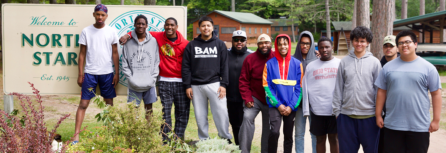 group of boys in front of Camp North Star sign