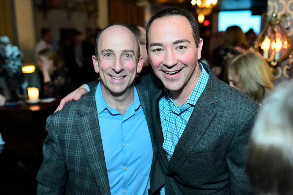 two men smiling for camera