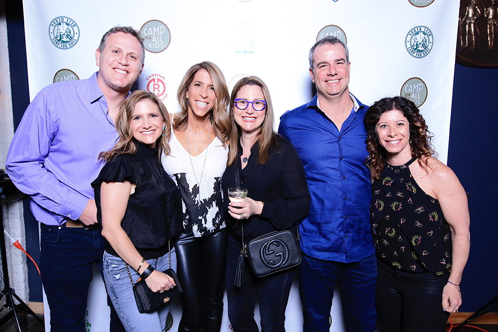 group of smiling attendees at the Cocktails around The Campfire event